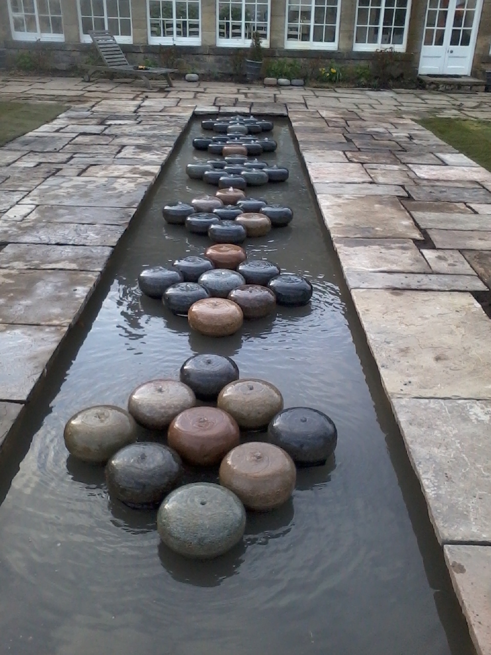 Curling stones on a reflective pond