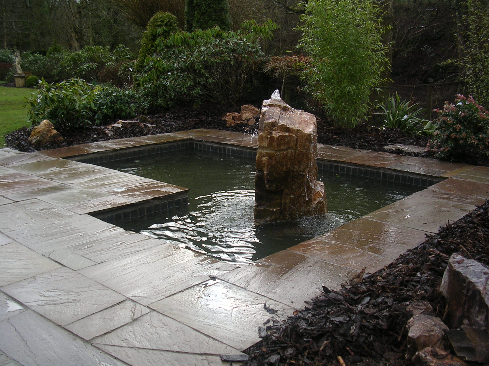 Bubble stone set within formal pond
