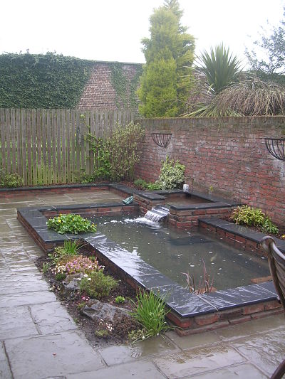 Raised brick pond with slate copping - Almond Landscapes